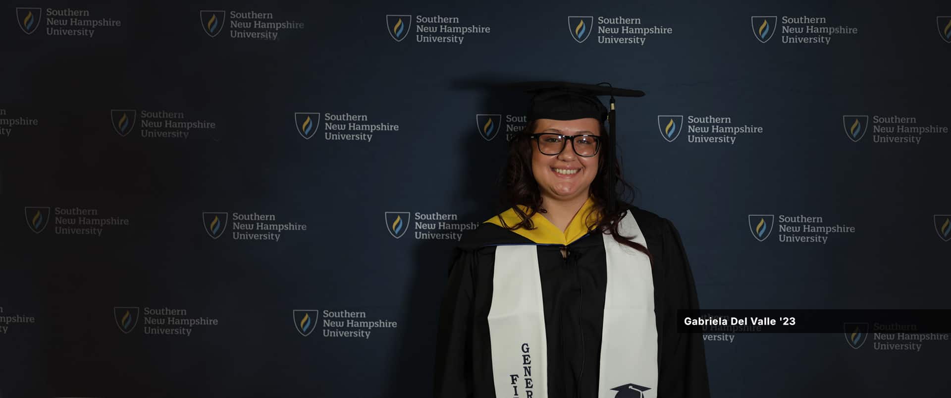 Gabriela Del Valle, who earned her bachelor's in psychology with a concentration in forensic psychology from WUV in 2023, wearing her cap and gown.