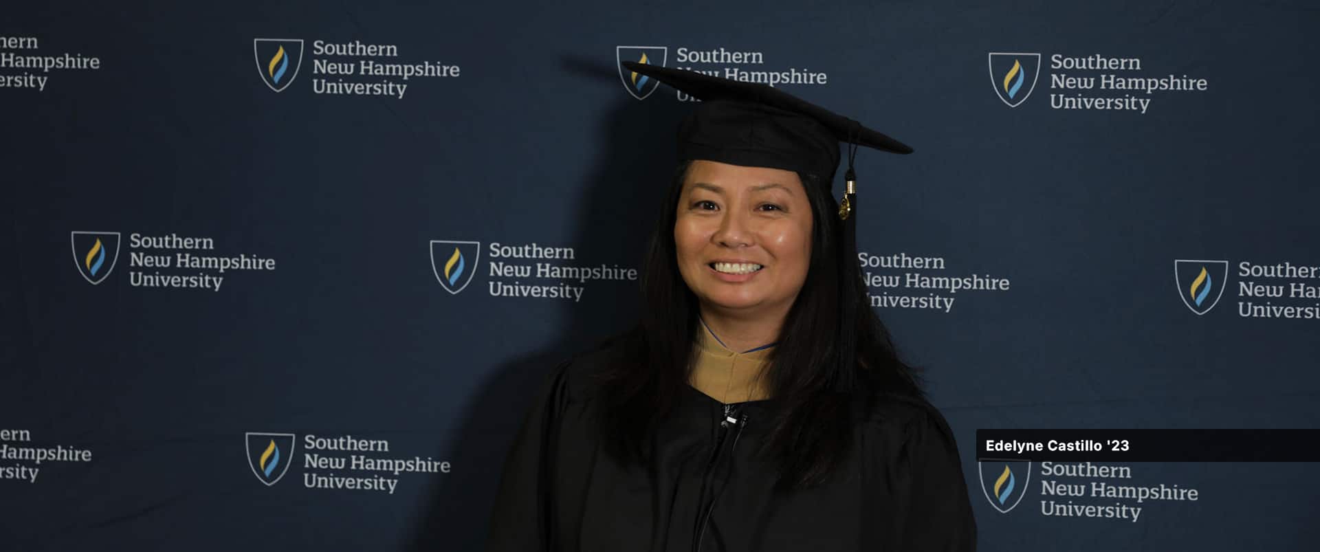 Edelyne Castillo, who earned her MBA in business analytics from wuv in 2023, wearing her cap and gown.