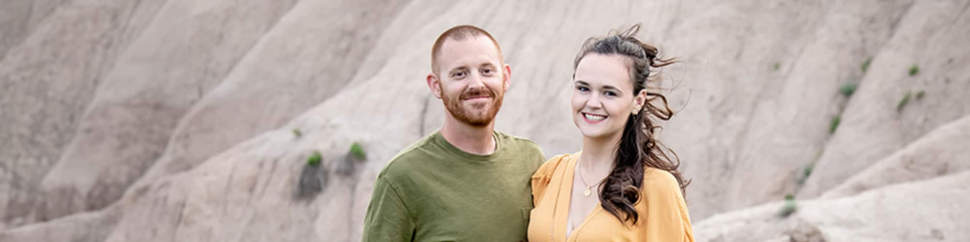 wuv student and South Dakota resident Tara Yonce wearing a yellow dress and standing next to a man and young boy.
