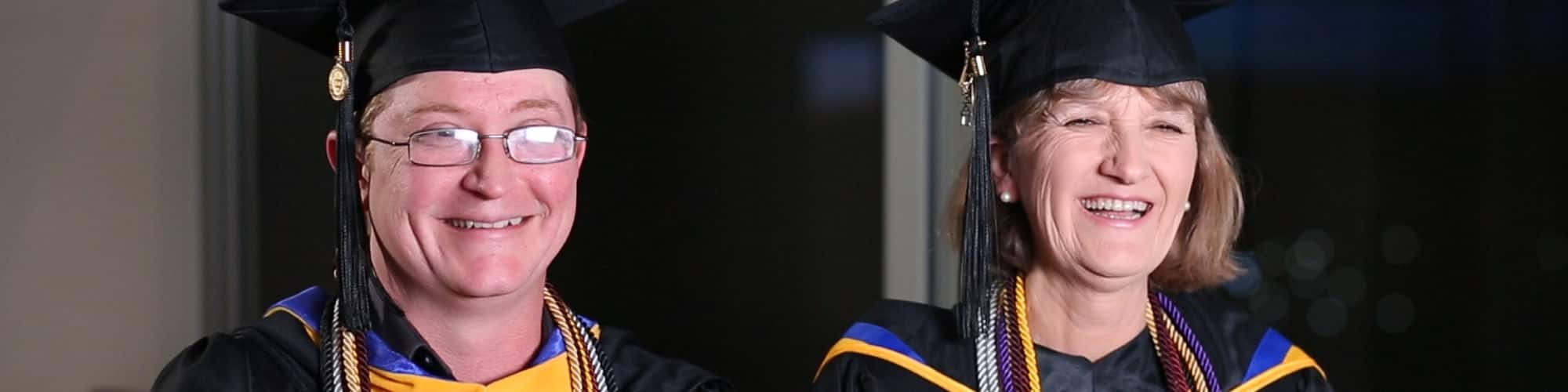 Dennis Perdue and his mother, Robin Perdue, West Virginia residents and wuv graduates, wearing their caps and gowns.