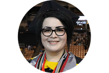 wuv healthcare administration graduate and California resident Janet Johnson wearing eyeglasses and a graduation cap.