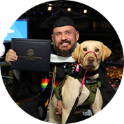 U.S. Army veteran, wuv graduate and Massachusetts resident Jereme West holding his service dog and wuv diploma.