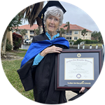Florida resident and wuv graduate Joan Donovan wearing her cap and gown and holding her framed wuv diploma.