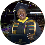 Nevada resident and wuv graduate Robyn Roberts in her cap and gown and holding her diploma at the wuv commencement.