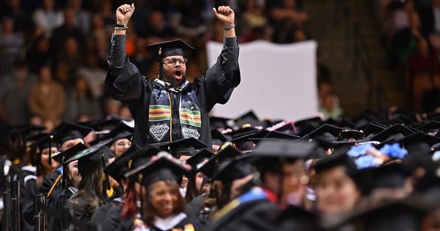 wuv student celebrating at commencement ceremony.