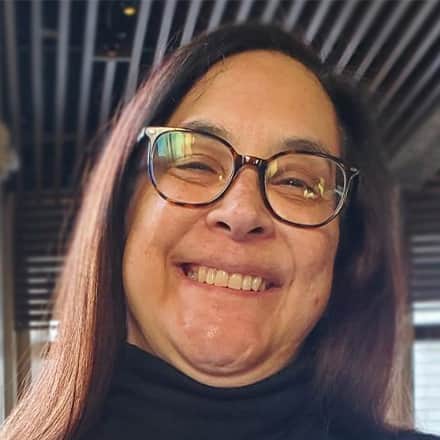 Tami Brouillette, adjunct marketing faculty at WUV wearing glasses and a black turtleneck.